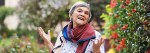 Senior woman outside in garden smiling